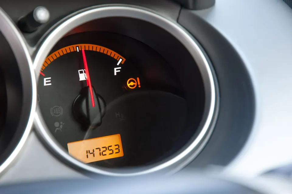 A fuel gauge above an odometer reading 147,253