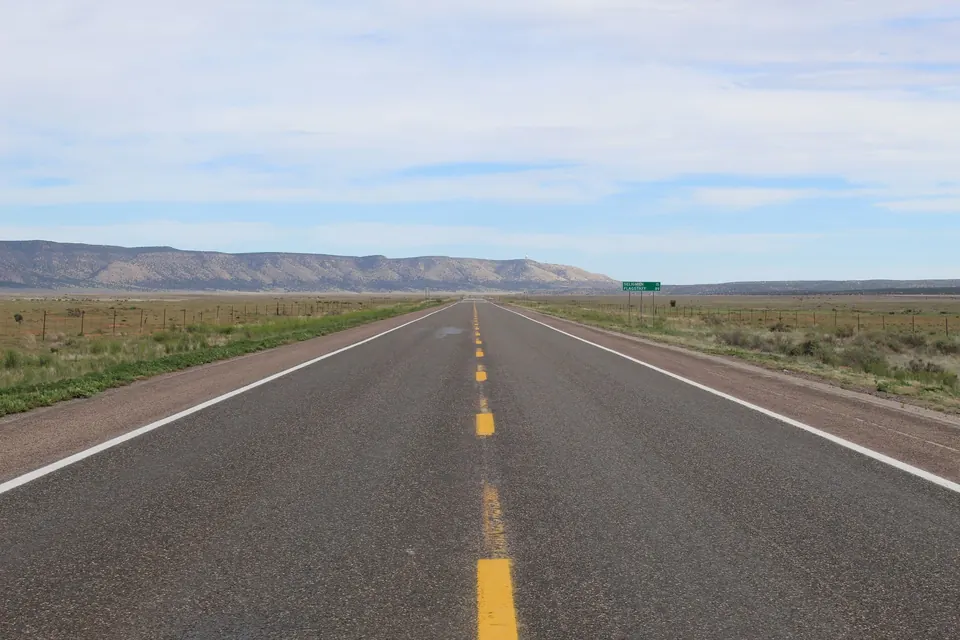 An open two-lane highway across high desert range land